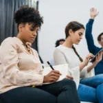 Business English Listening Comprehension - working professionals in a training seminar represent the mindset shift